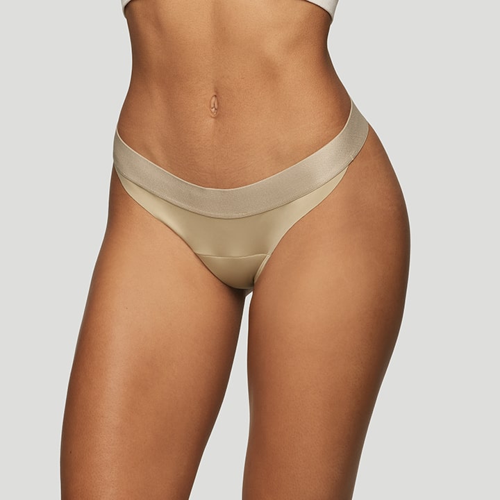 JIV ATHLETICS The Cameltoe Proof Mid Rise Thong In Neutral. - Size